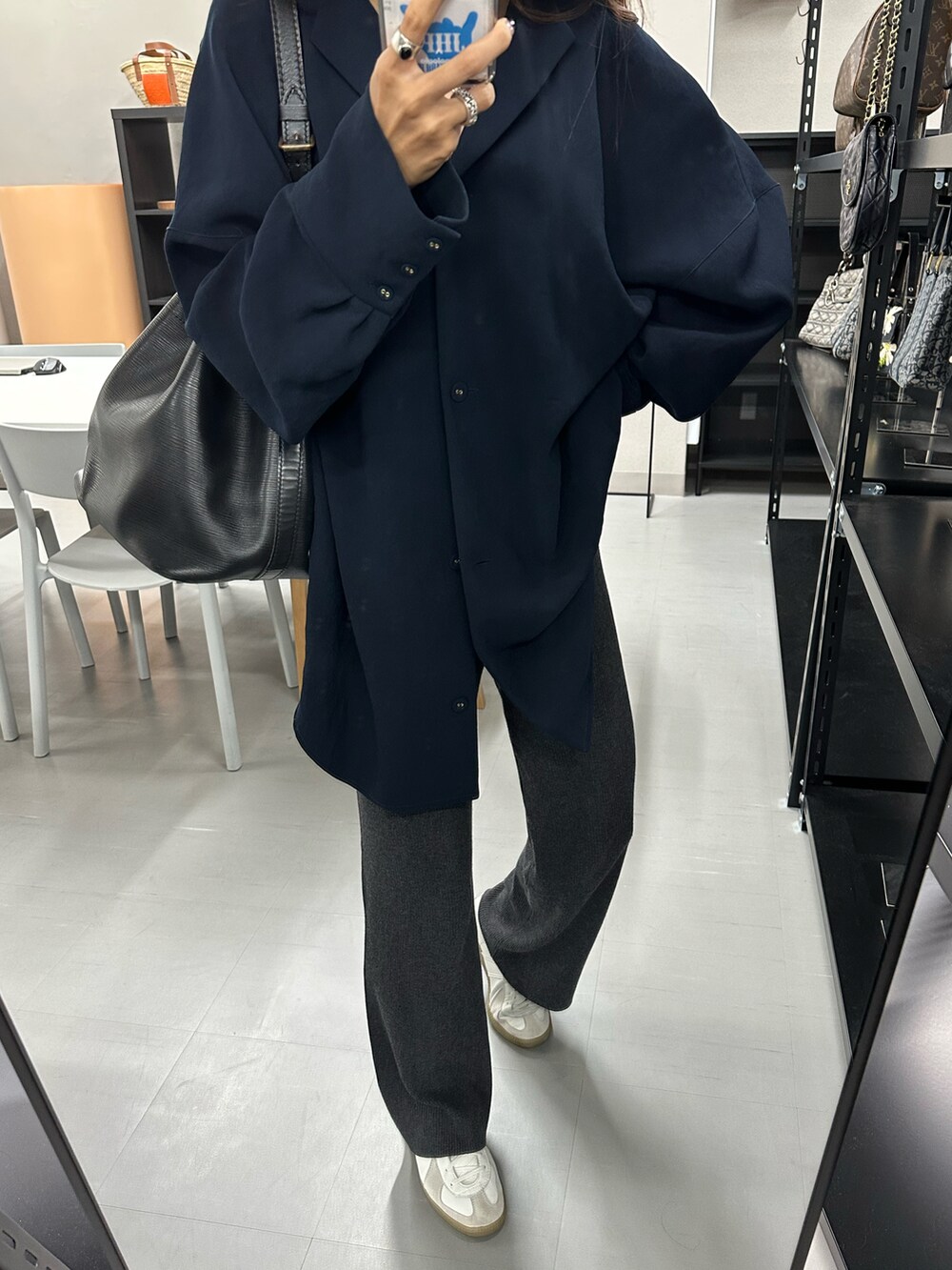 ブルー系のシャツ/ブラウス、グレー系のパンツ、ホワイト系のスニーカーを着用したレディースの秋コーディネートの2枚目の写真