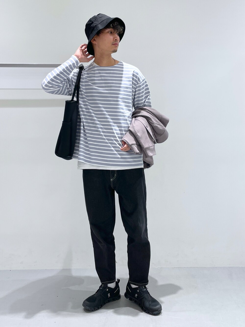 ブラック系のデニムパンツ、パープル系のTシャツ/カットソー、グレー系のカーディガン/ボレロを着用したメンズの冬コーディネートの3枚目の写真