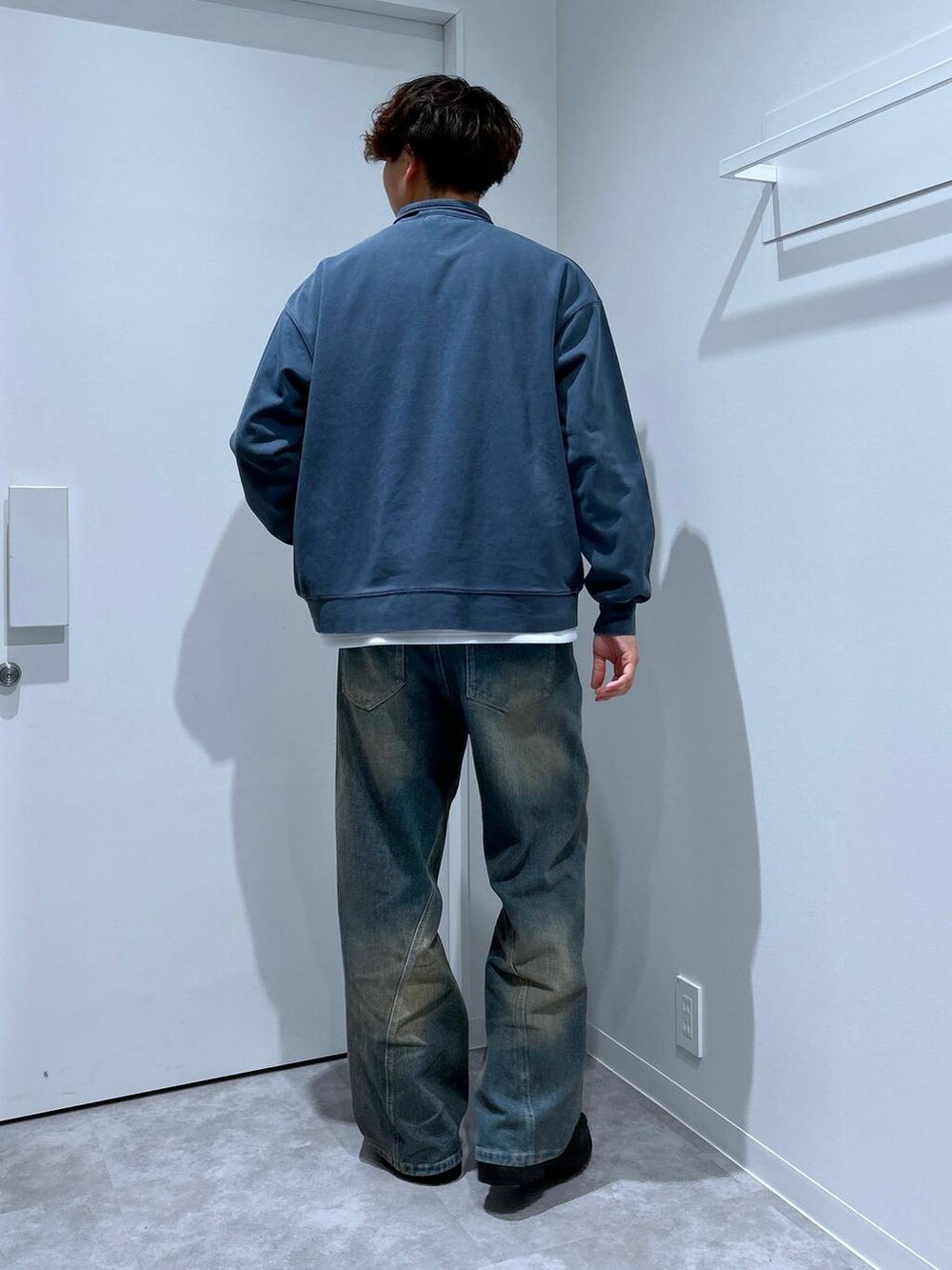 ホワイト系のTシャツ/カットソー、ブルー系のデニムパンツ、ブラック系のローファーを着用したメンズの冬コーディネートの3枚目の写真