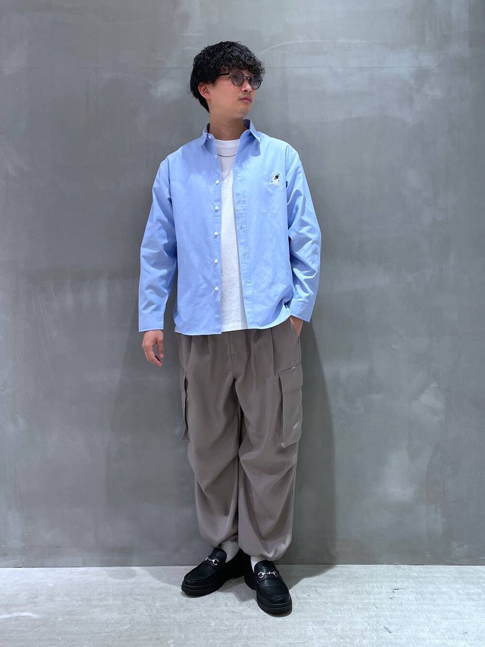 ホワイト系のTシャツ/カットソー、ブラック系のローファー、グレー系のカーゴパンツを着用したメンズの春コーディネートの4枚目の写真