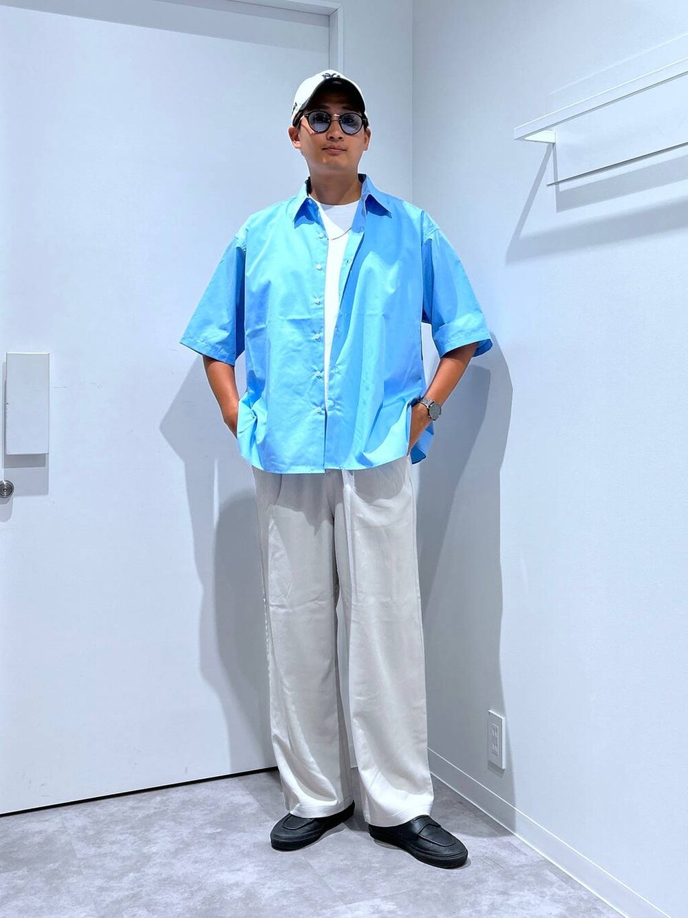 ブルー系のシャツ/ブラウス、ベージュ系のその他パンツ、ブラック系のサングラスを着用したメンズの夏コーディネートの4枚目の写真