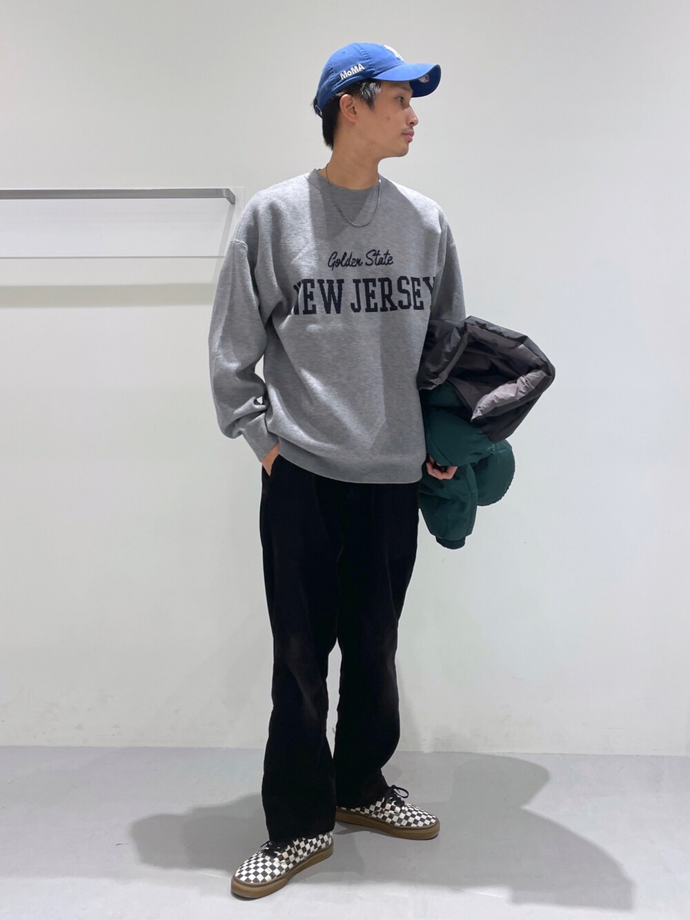 グリーン系のブルゾン、ブラック系のその他パンツ、グレー系のニット/セーターを着用したメンズの冬コーディネートの2枚目の写真