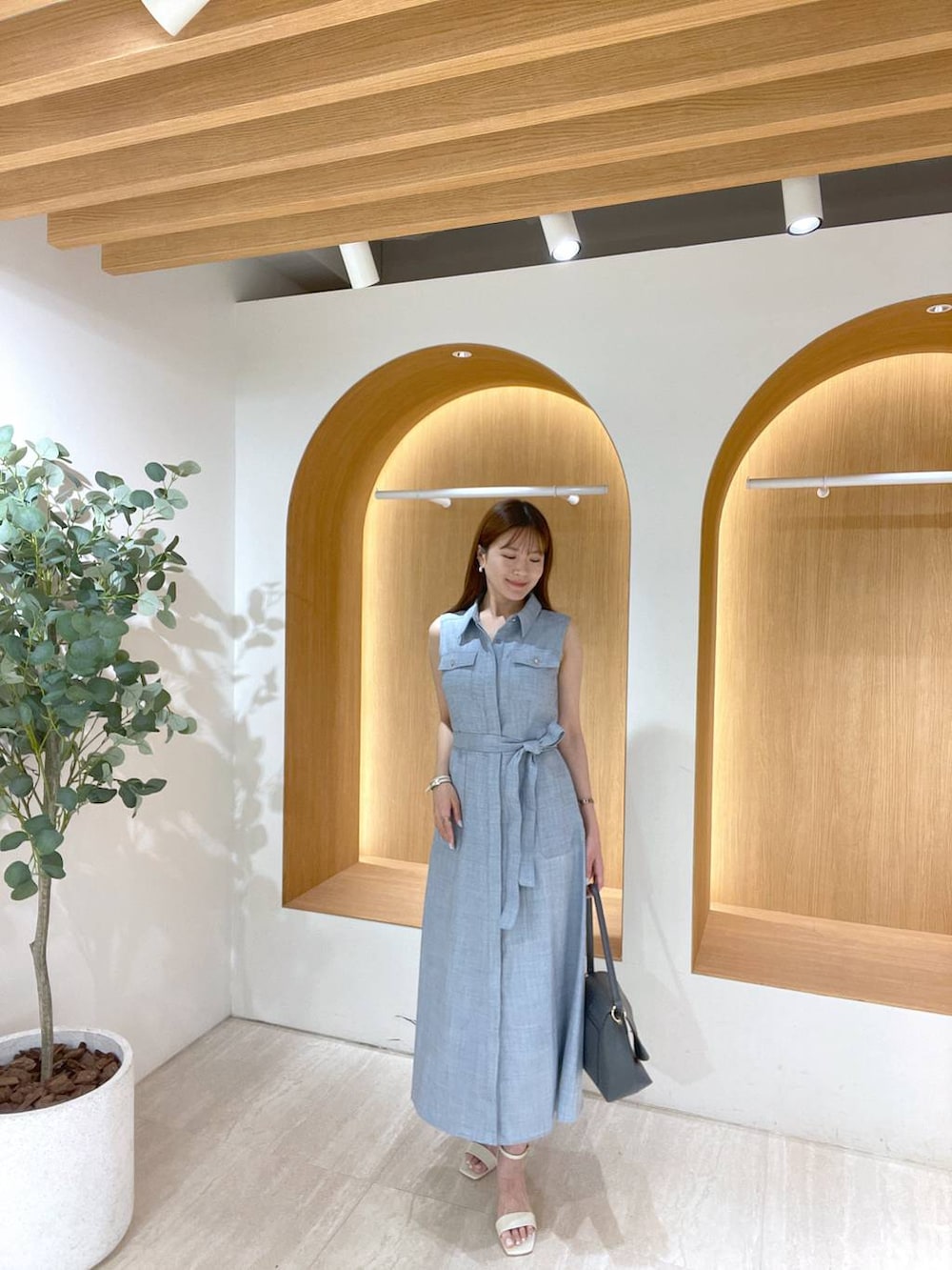 ホワイト系のサンダル、グレー系のハンドバッグ、ブルー系のワンピースを着用したレディースの夏コーディネートの4枚目の写真