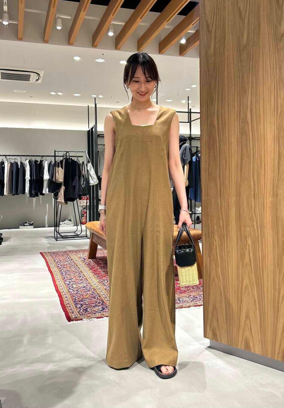 イエロー系のサロペット/オーバーオール、ブラック系のサンダルを着用したレディースの夏コーディネートの2枚目の写真