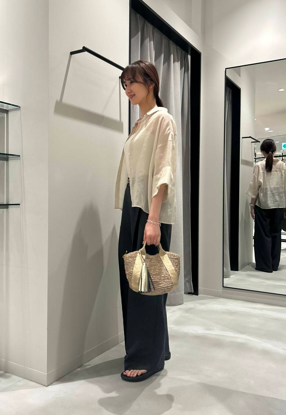 ゴールド系のかごバッグ、ブラック系のサンダル、グレー系のその他パンツを着用したレディースの夏コーディネートの3枚目の写真