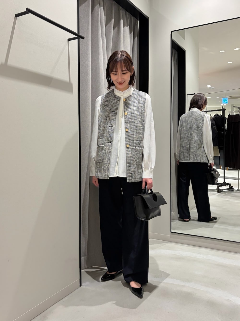 ブラック系のその他アウター、ホワイト系のシャツ/ブラウス、ブラック系のその他パンツを着用したレディースの冬コーディネートの2枚目の写真