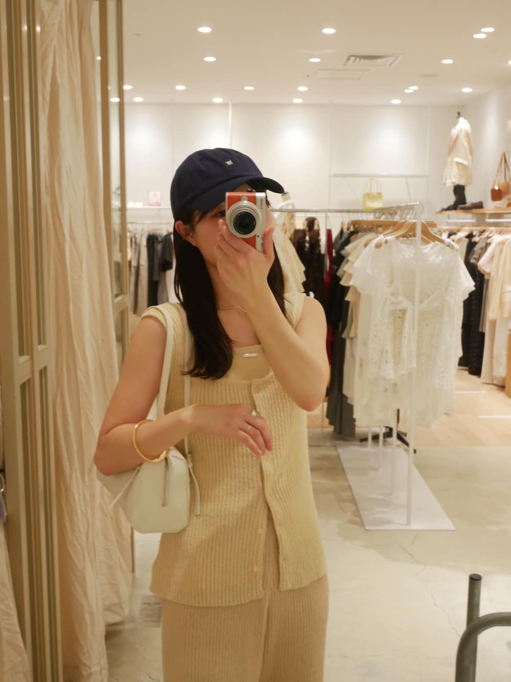 ホワイト系のニット/セーター、ホワイト系のその他パンツ、ホワイト系のボストンバッグを着用したレディースの春コーディネートの2枚目の写真