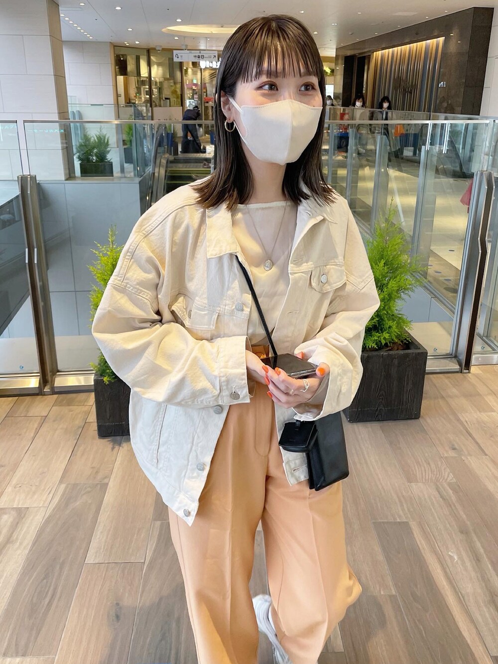 オレンジ系のその他パンツ、ホワイト系のデニムジャケットを着用したレディースの春コーディネートの2枚目の写真