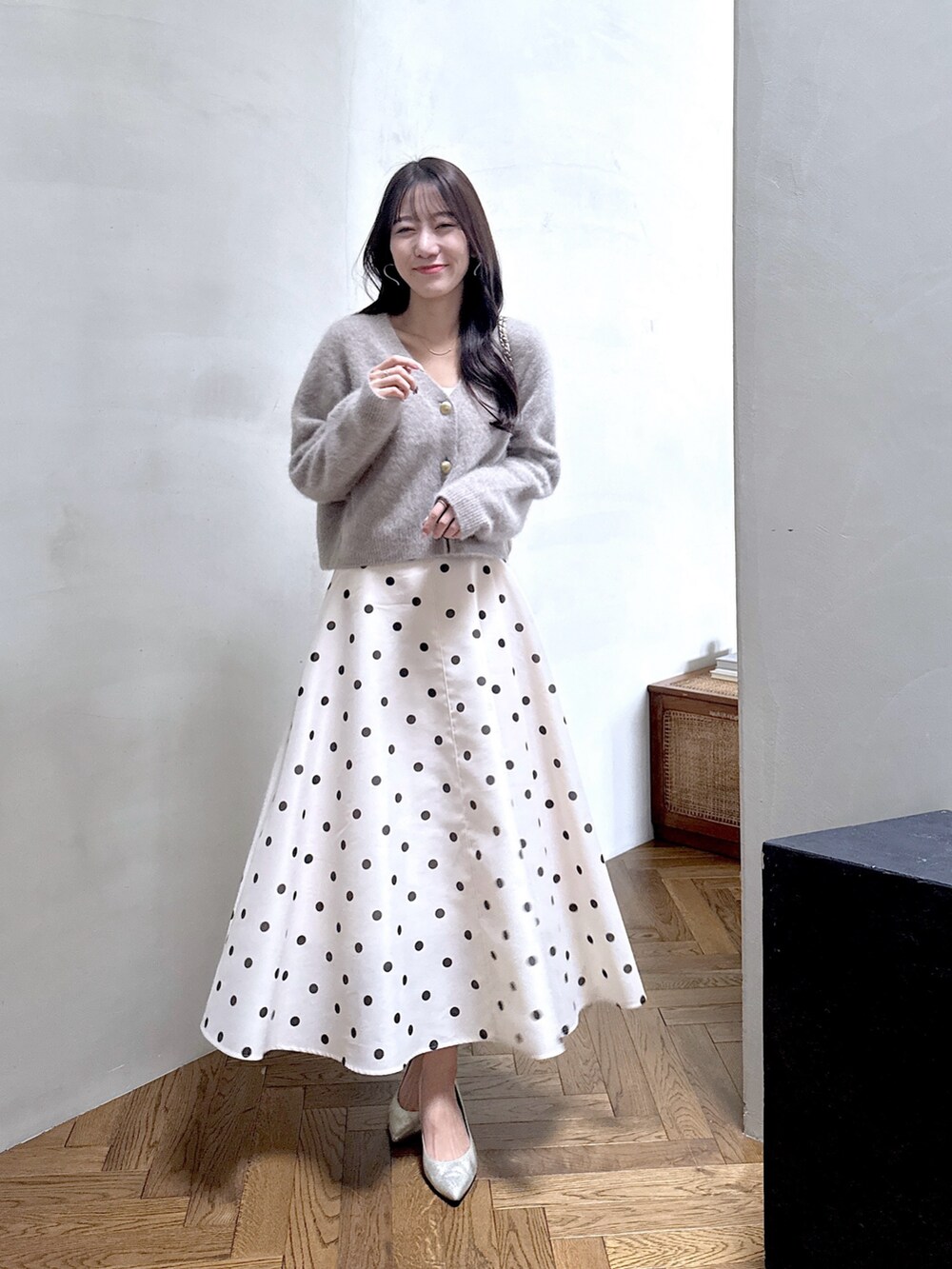 ブラウン系のカーディガン/ボレロ、ベージュ系のスカートを着用したレディースの秋コーディネートの2枚目の写真