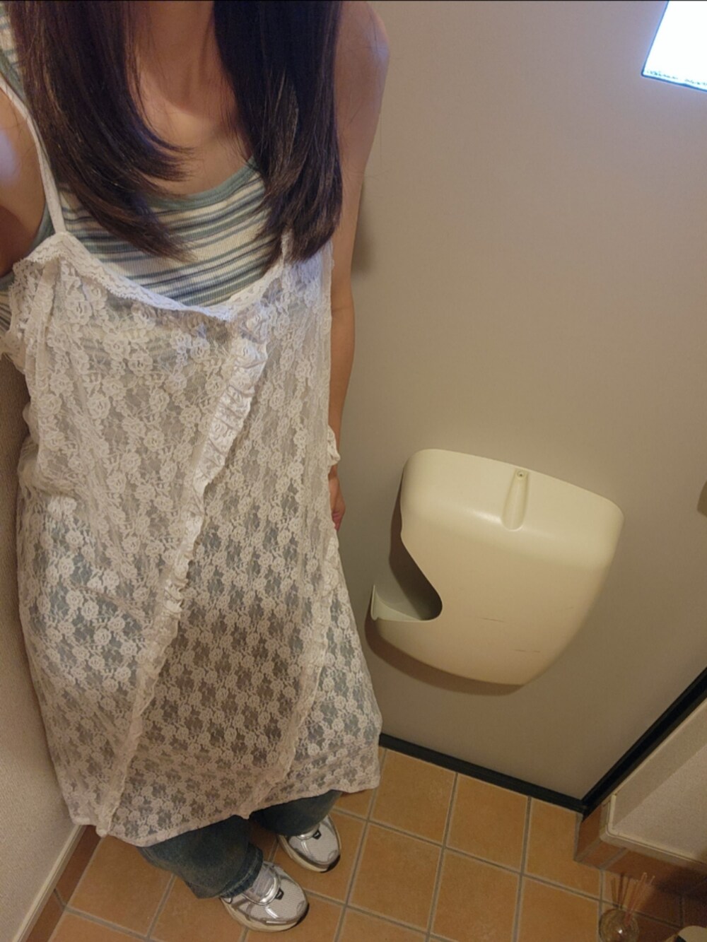 ブルー系のデニムパンツ、ホワイト系のスニーカー、ホワイト系のワンピース/ドレスを着用したレディースの夏コーディネートの2枚目の写真