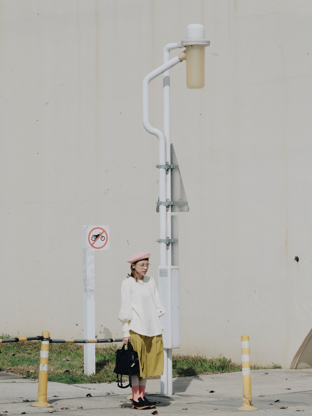 イエロー系のカーゴパンツ、ブラック系のバッグ、ベージュ系のトップスを着用したレディースの春コーディネートの4枚目の写真