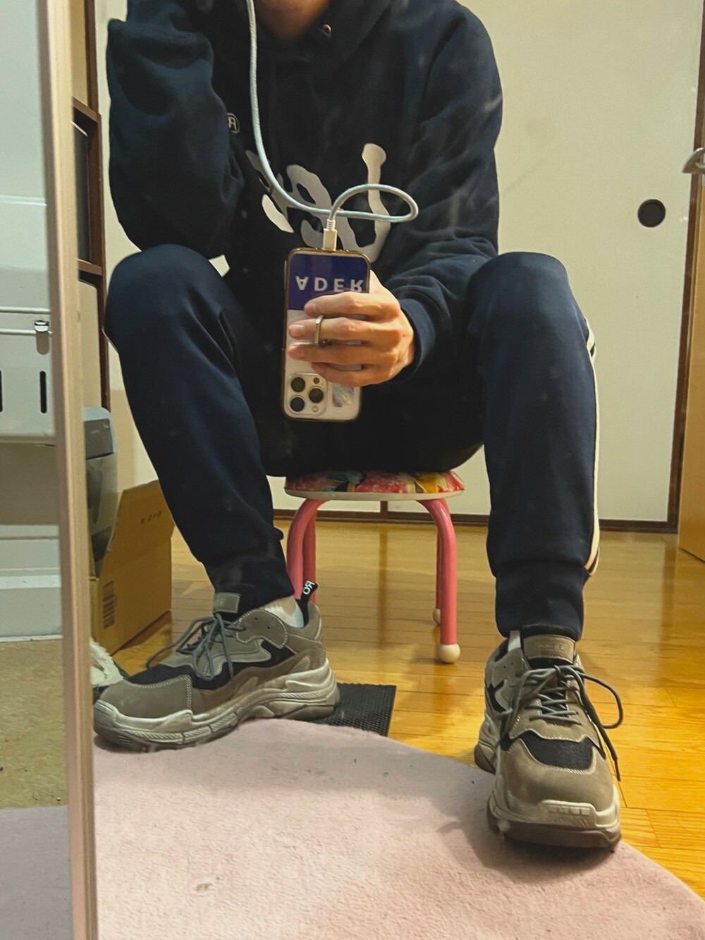 ブラック系のナイロンジャケット、ブラック系のショルダーバッグ、ブラック系のスラックスを着用したメンズの冬コーディネートの3枚目の写真