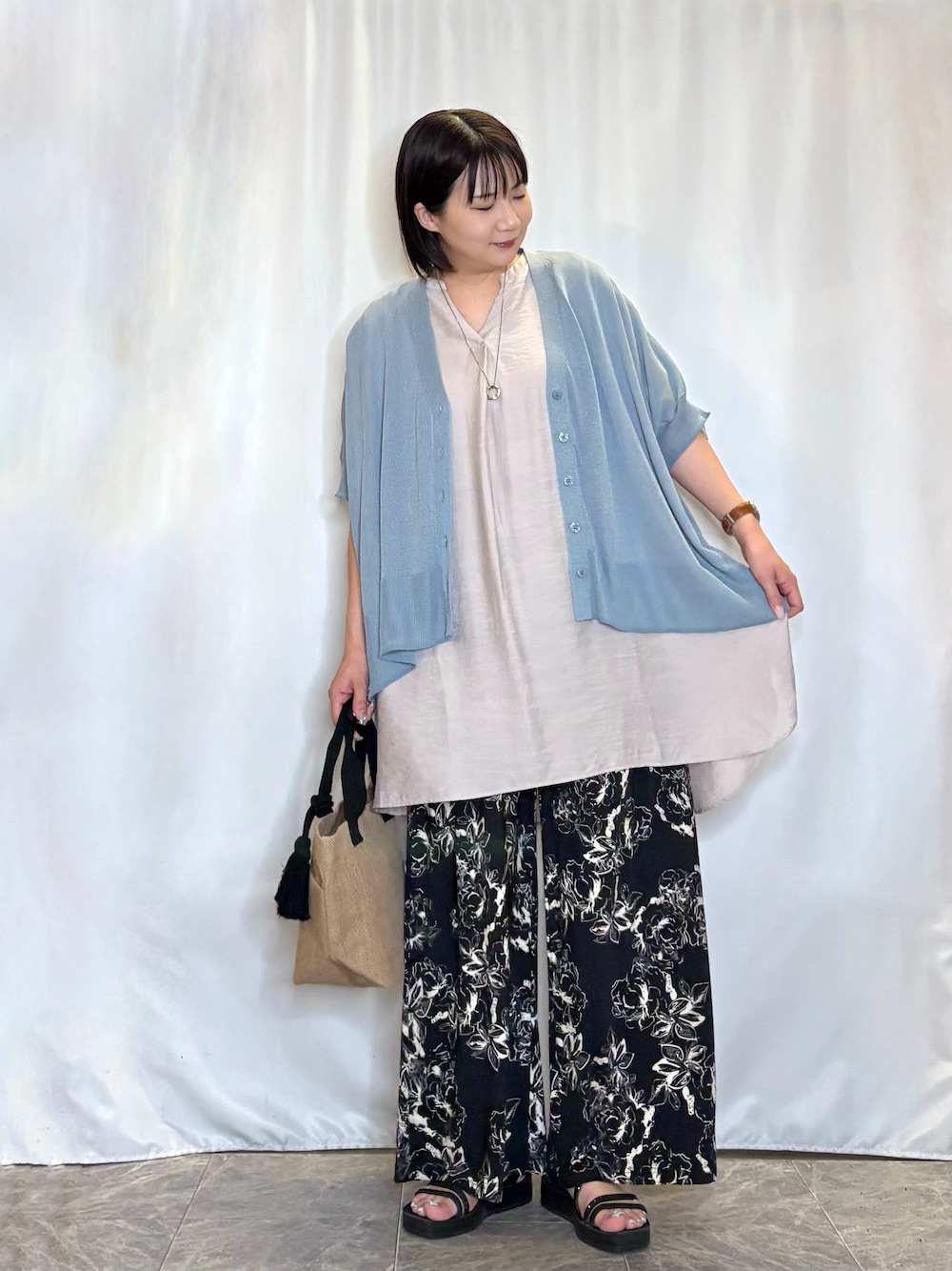 ブルー系のカーディガン/ボレロ、ベージュ系のチュニック、ブラック系のその他パンツを着用したレディースの夏コーディネートの2枚目の写真