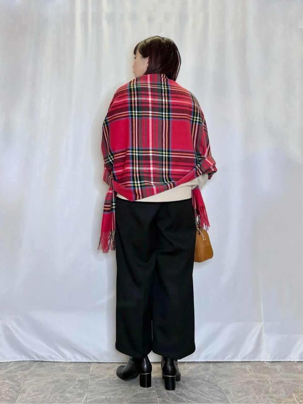 ベージュ系のニット/セーター、ブラック系のその他パンツ、ブラック系のブーツを着用したレディースの冬コーディネートの3枚目の写真