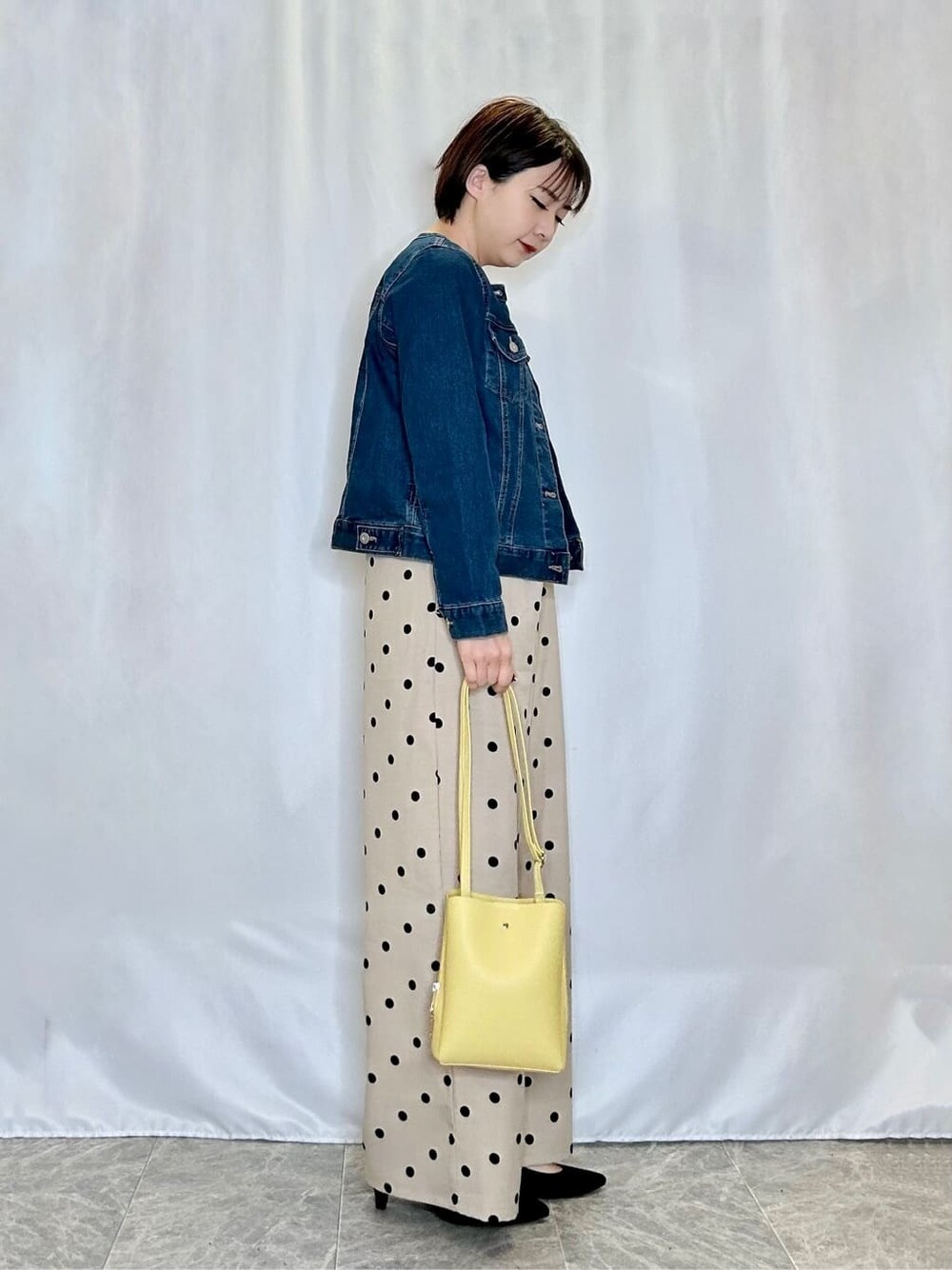 ブルー系のデニムジャケット、ベージュ系のサロペット/オーバーオール、ホワイト系のTシャツ/カットソーを着用したレディースの春コーディネートの2枚目の写真