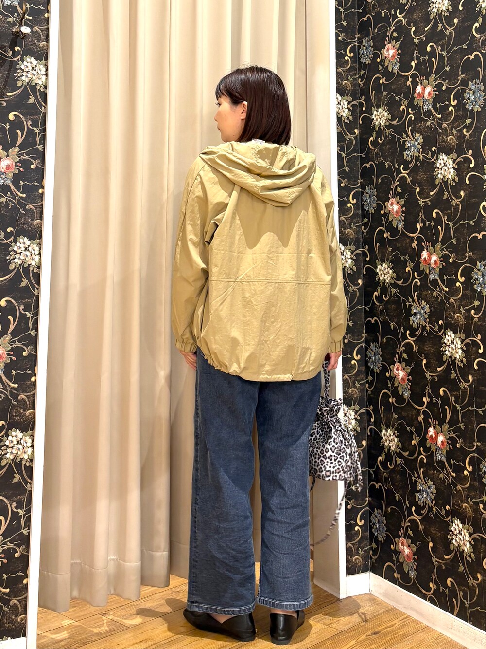 ベージュ系のブルゾン、ホワイト系のTシャツ/カットソー、ブルー系のデニムパンツを着用したレディースの秋コーディネートの3枚目の写真