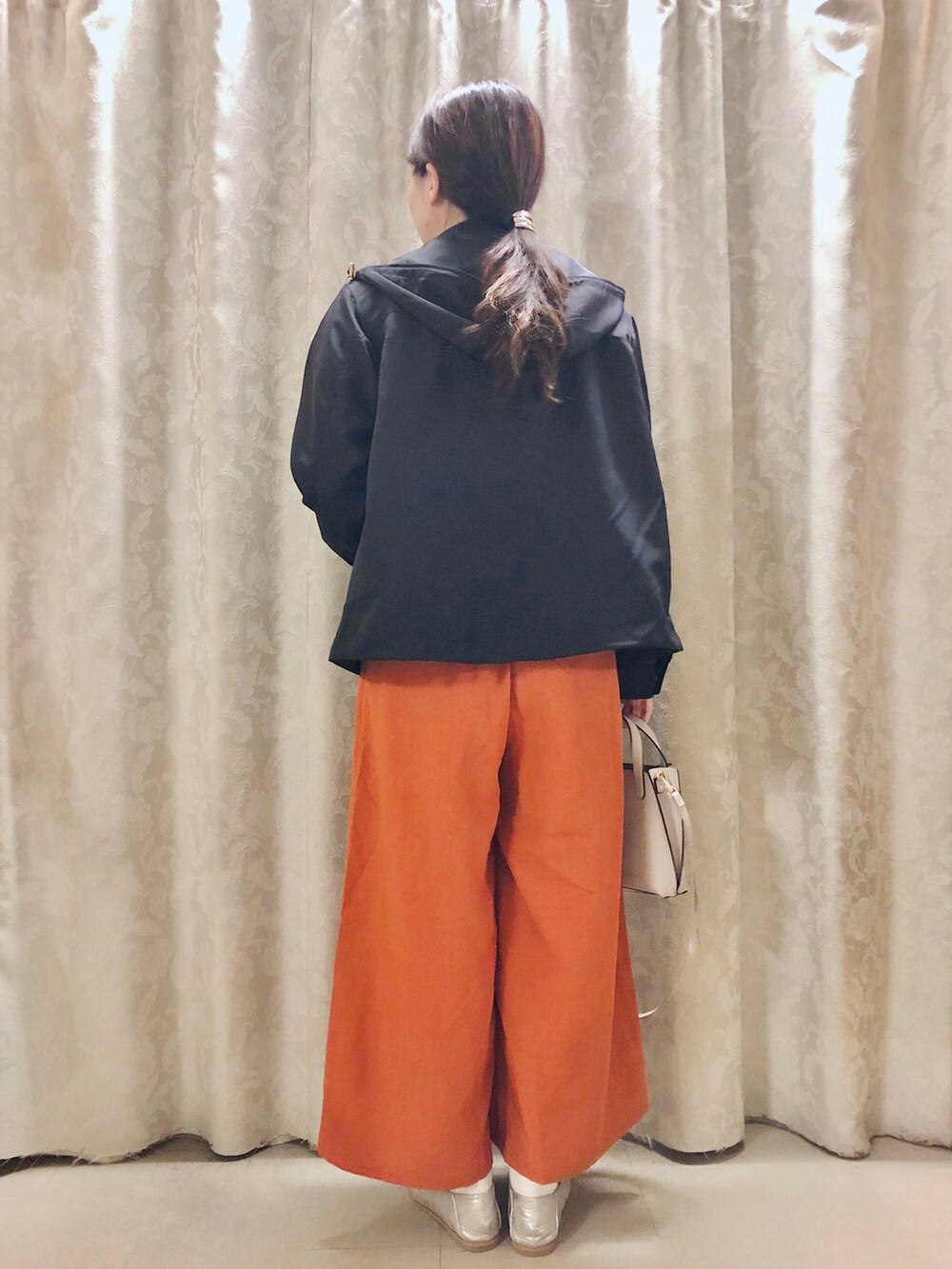 ブルー系のブルゾン、オレンジ系のその他パンツ、グレー系のショルダーバッグを着用したレディースの春コーディネートの3枚目の写真