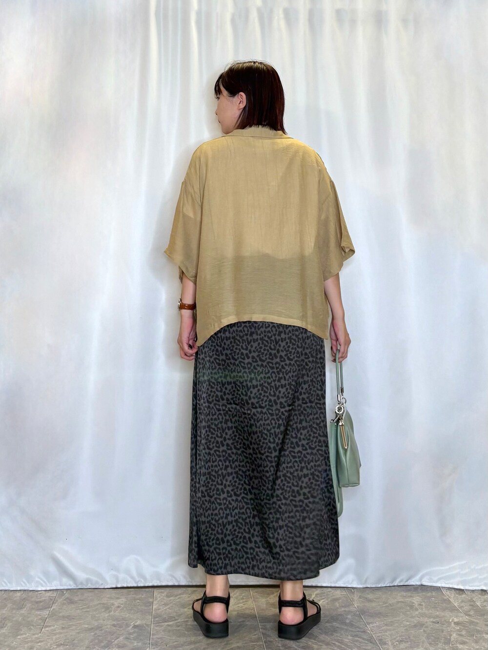 ブラウン系のシャツ/ブラウス、ホワイト系のTシャツ/カットソー、グレー系のスカートを着用したレディースの夏コーディネートの5枚目の写真