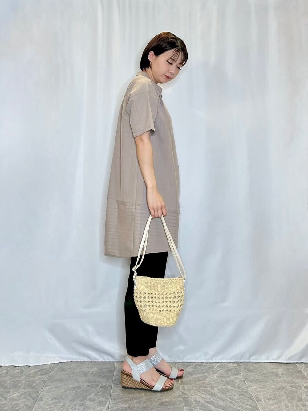 ベージュ系のチュニック、ブラック系のその他パンツ、シルバー系のサンダルを着用したレディースの夏コーディネートの2枚目の写真