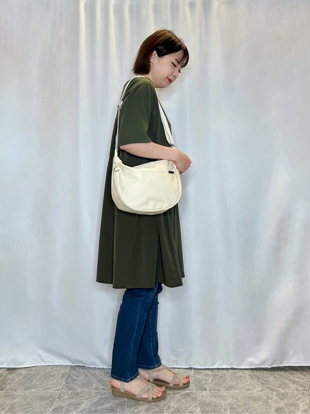 ブルー系のデニムパンツを着用したレディースの春コーディネートの2枚目の写真
