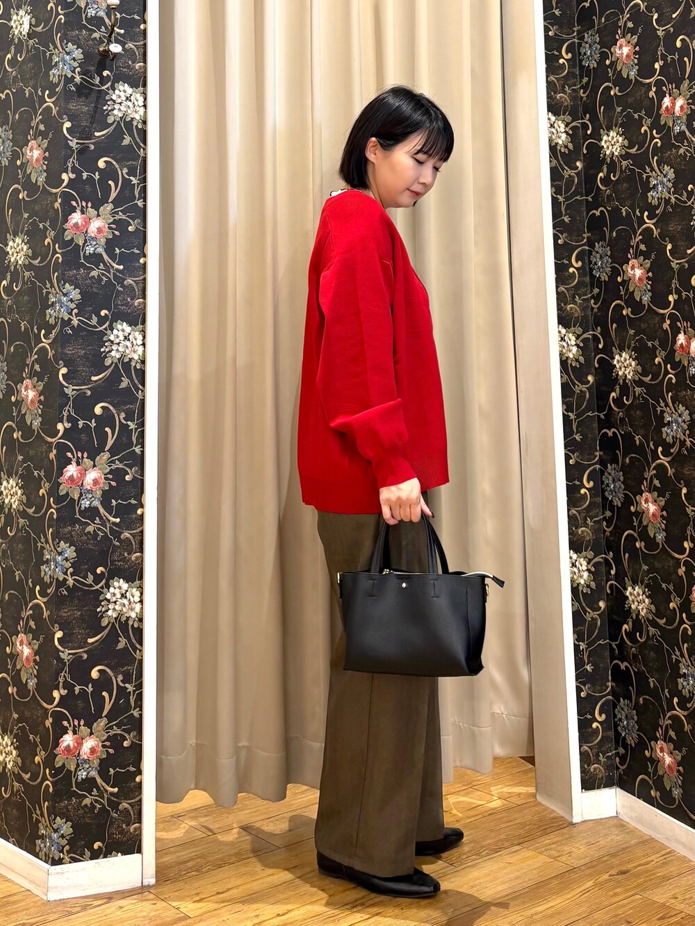 レッド系のカーディガン/ボレロ、ホワイト系のTシャツ/カットソー、ブラック系のトートバッグを着用したレディースの秋コーディネートの2枚目の写真