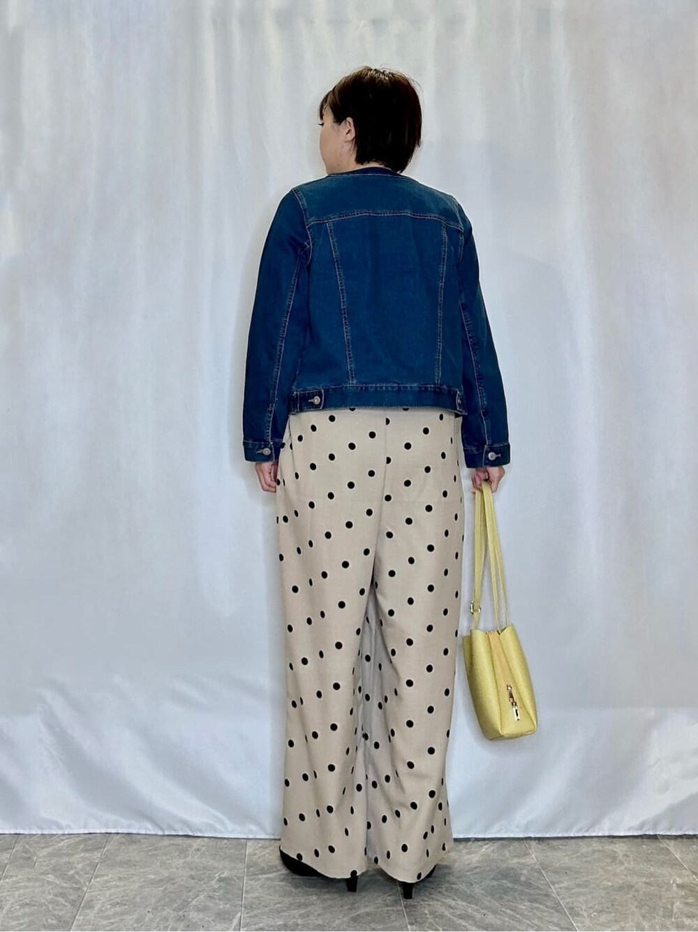 ブルー系のデニムジャケット、ベージュ系のサロペット/オーバーオール、ホワイト系のTシャツ/カットソーを着用したレディースの春コーディネートの3枚目の写真