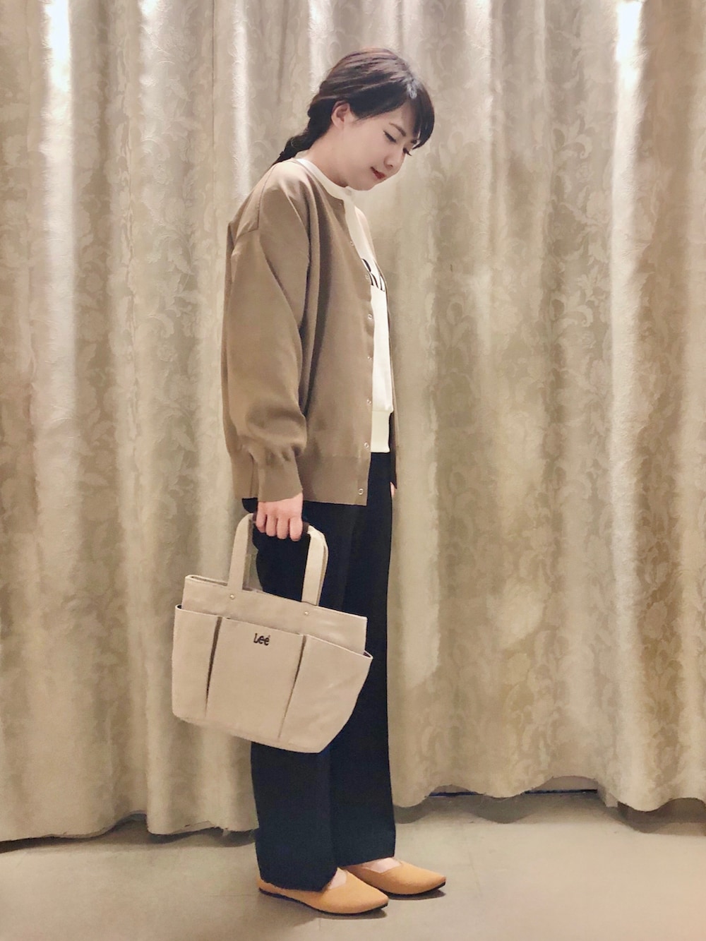 ベージュ系のスウェット、ブラウン系のカーディガン/ボレロ、ブラック系のその他パンツを着用したレディースの秋コーディネートの2枚目の写真