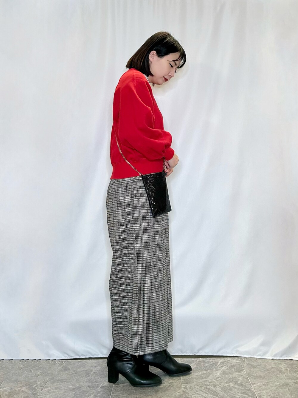 ブラック系のブーツ、レッド系のTシャツ/カットソー、ベージュ系のその他パンツを着用したレディースの冬コーディネートの2枚目の写真