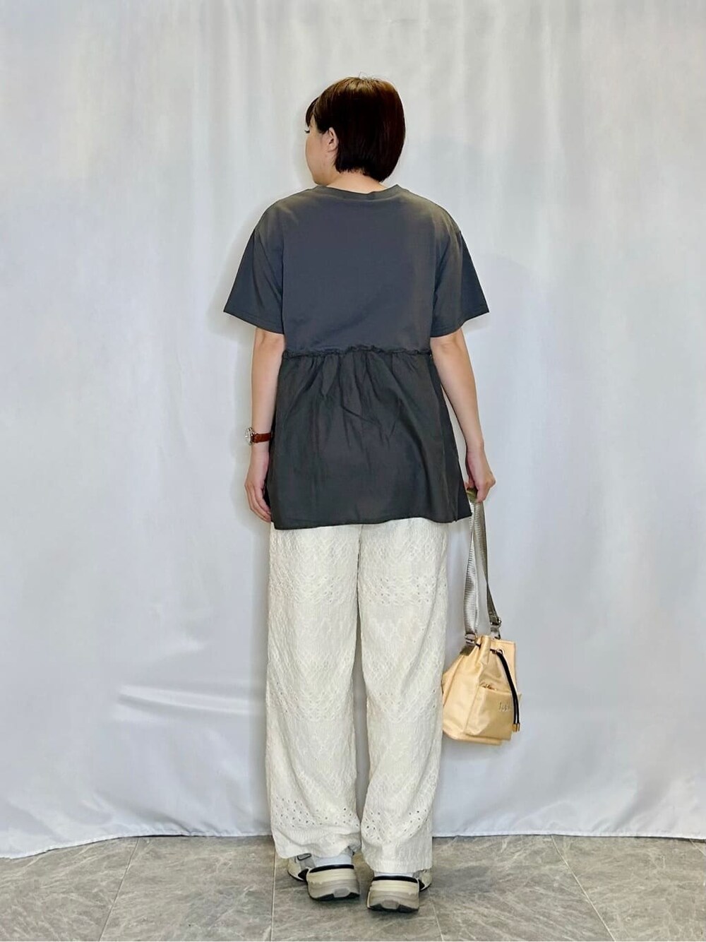 グレー系のTシャツ/カットソー、ホワイト系のその他パンツ、イエロー系のショルダーバッグを着用したレディースの春コーディネートの3枚目の写真