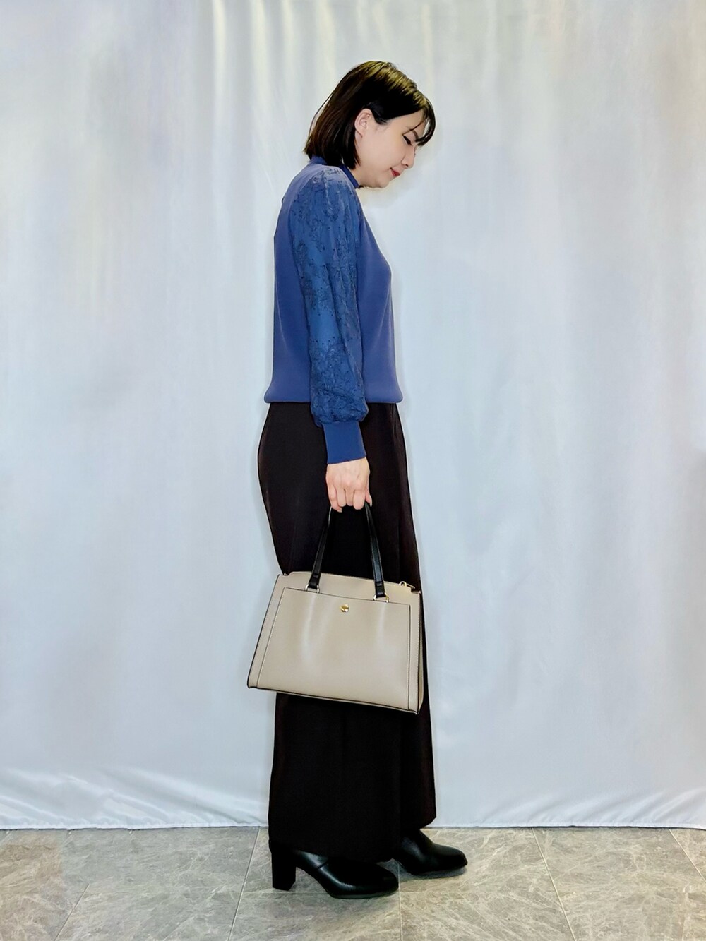 ブラック系のブーツ、ベージュ系のトートバッグ、ブラウン系のその他パンツを着用したレディースの秋コーディネートの2枚目の写真
