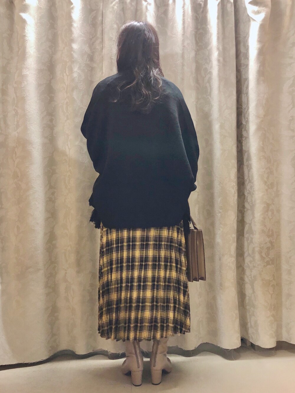 ホワイト系のTシャツ/カットソー、ブラック系のポンチョ、ベージュ系のショルダーバッグを着用したレディースの秋コーディネートの3枚目の写真