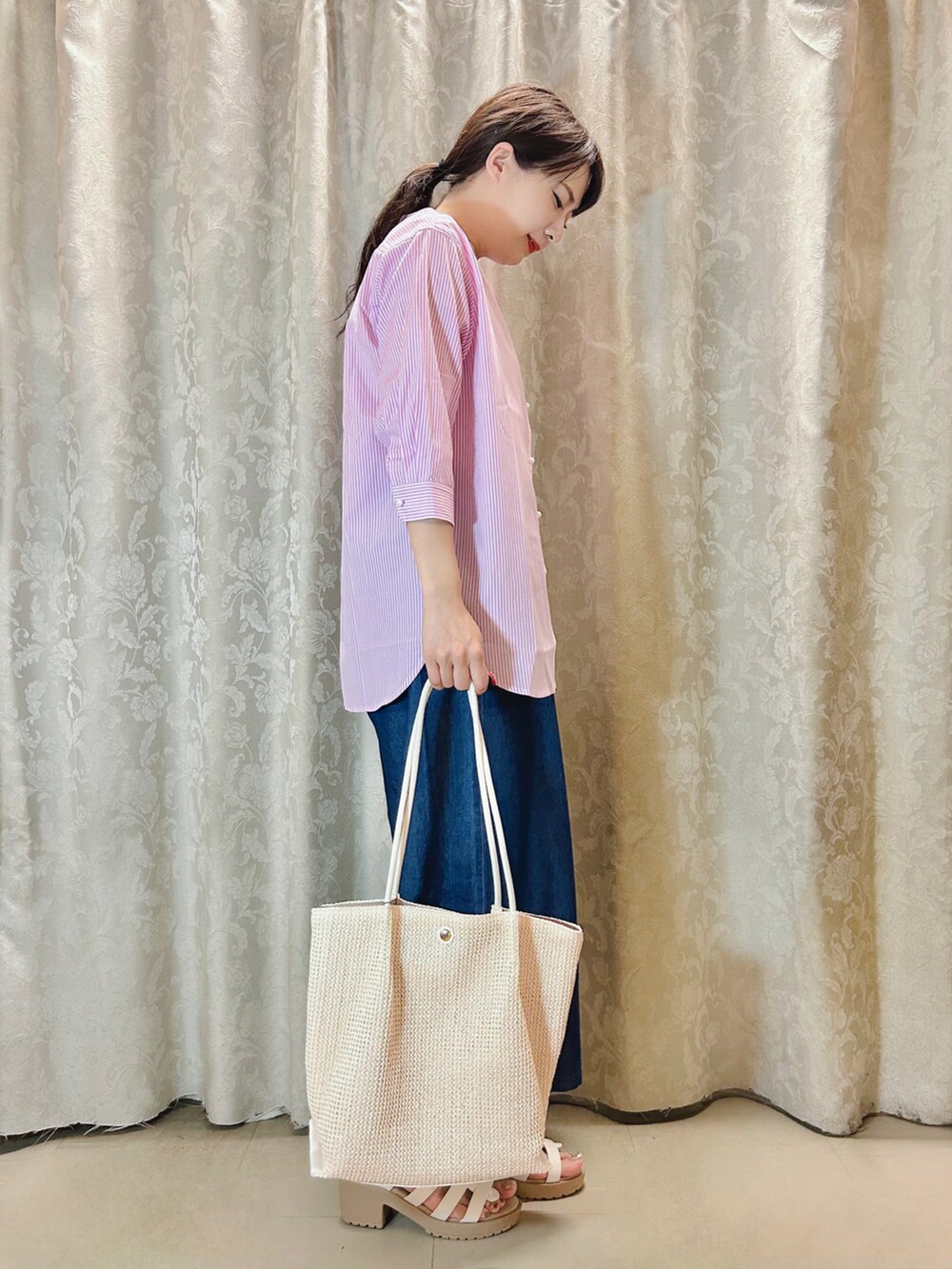 ホワイト系のサンダル、ホワイト系のトートバッグ、ピンク系のシャツ/ブラウスを着用したレディースの夏コーディネートの2枚目の写真