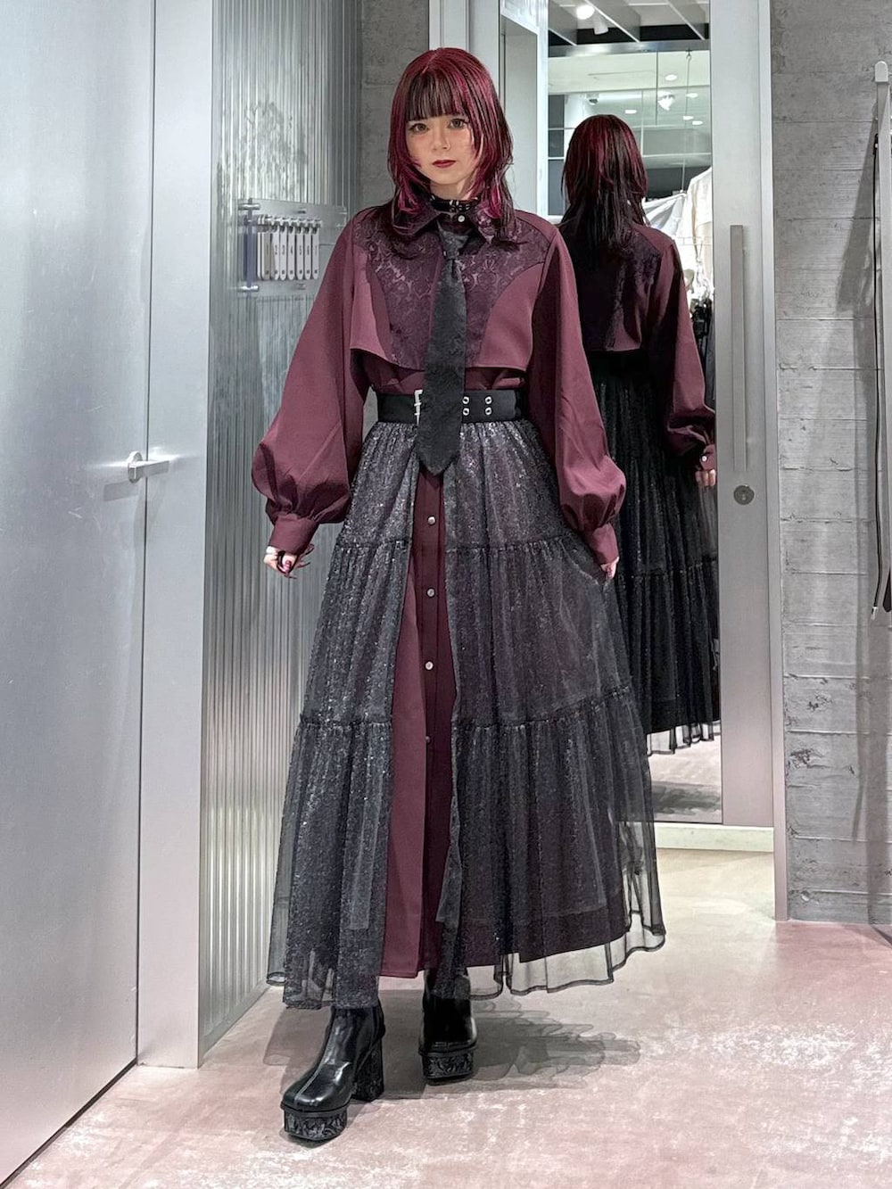 ブラック系のシャツ/ブラウス、グレー系のブーツ、その他のスカートを着用したレディースの秋コーディネートの2枚目の写真