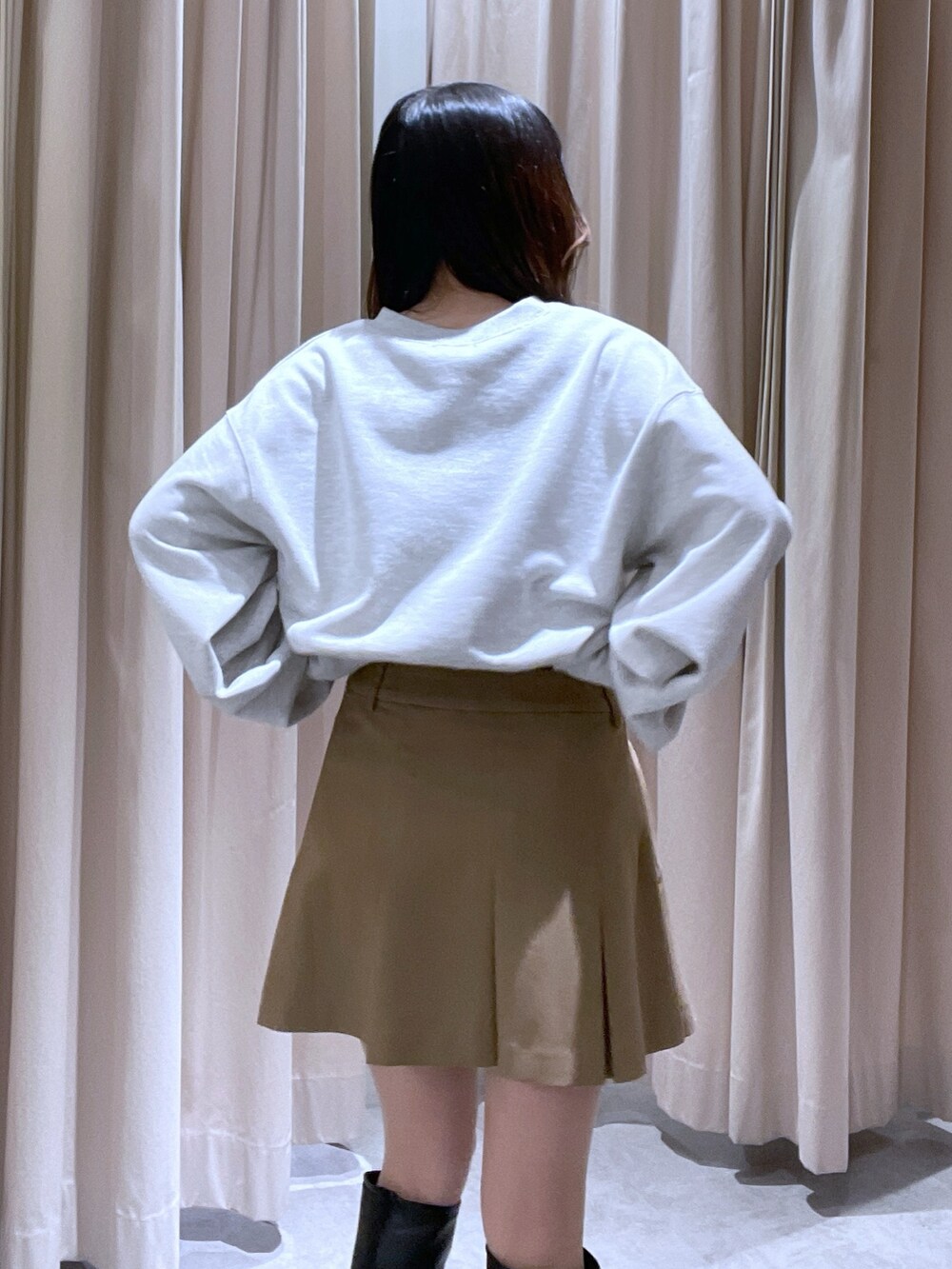 ホワイト系のスウェット、ベージュ系のスカートを着用したレディースの冬コーディネートの2枚目の写真