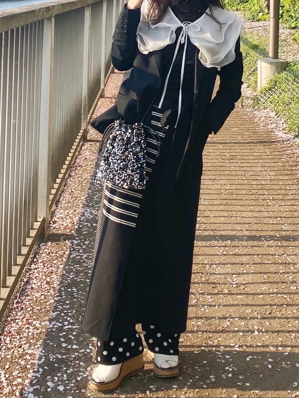 ブラック系のワンピース、その他のシューズ、ブラック系のテーラードジャケットを着用したレディースの春コーディネートの2枚目の写真