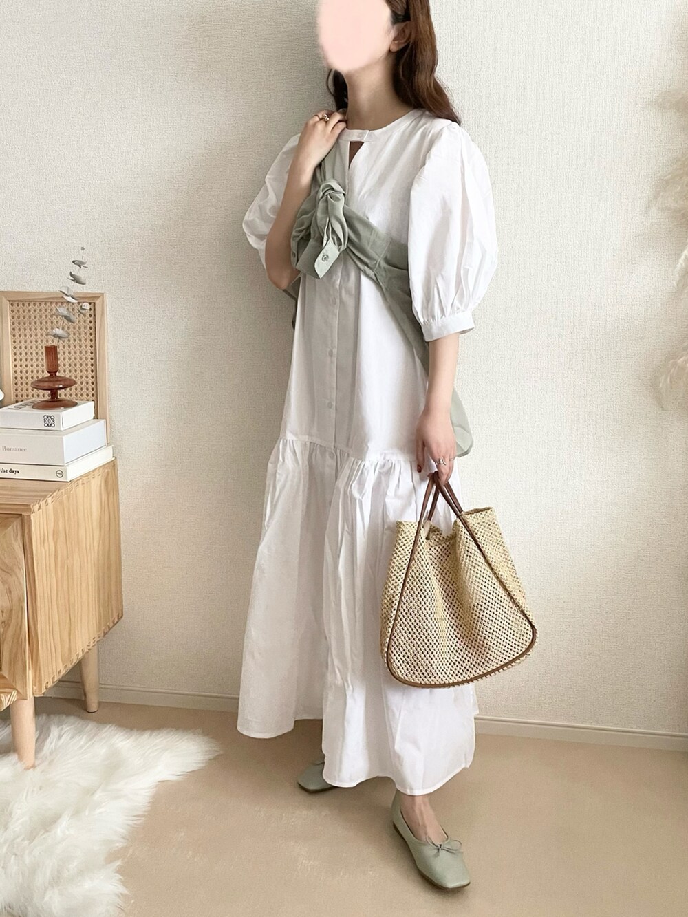 ホワイト系のシャツワンピース、ベージュ系のベスト、ブラウン系のトートバッグを着用したレディースの夏コーディネートの3枚目の写真