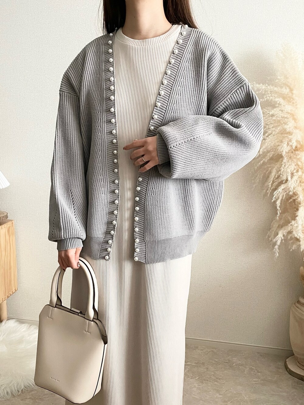 グレー系のカーディガン/ボレロ、ベージュ系のワンピース/ドレス、ブラウン系のバッグを着用したレディースの冬コーディネートの4枚目の写真