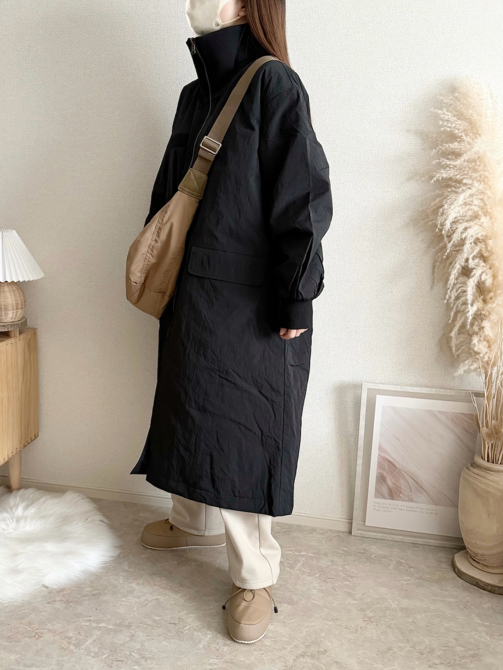 ブラック系のモッズコートを着用したレディースの冬コーディネートの3枚目の写真