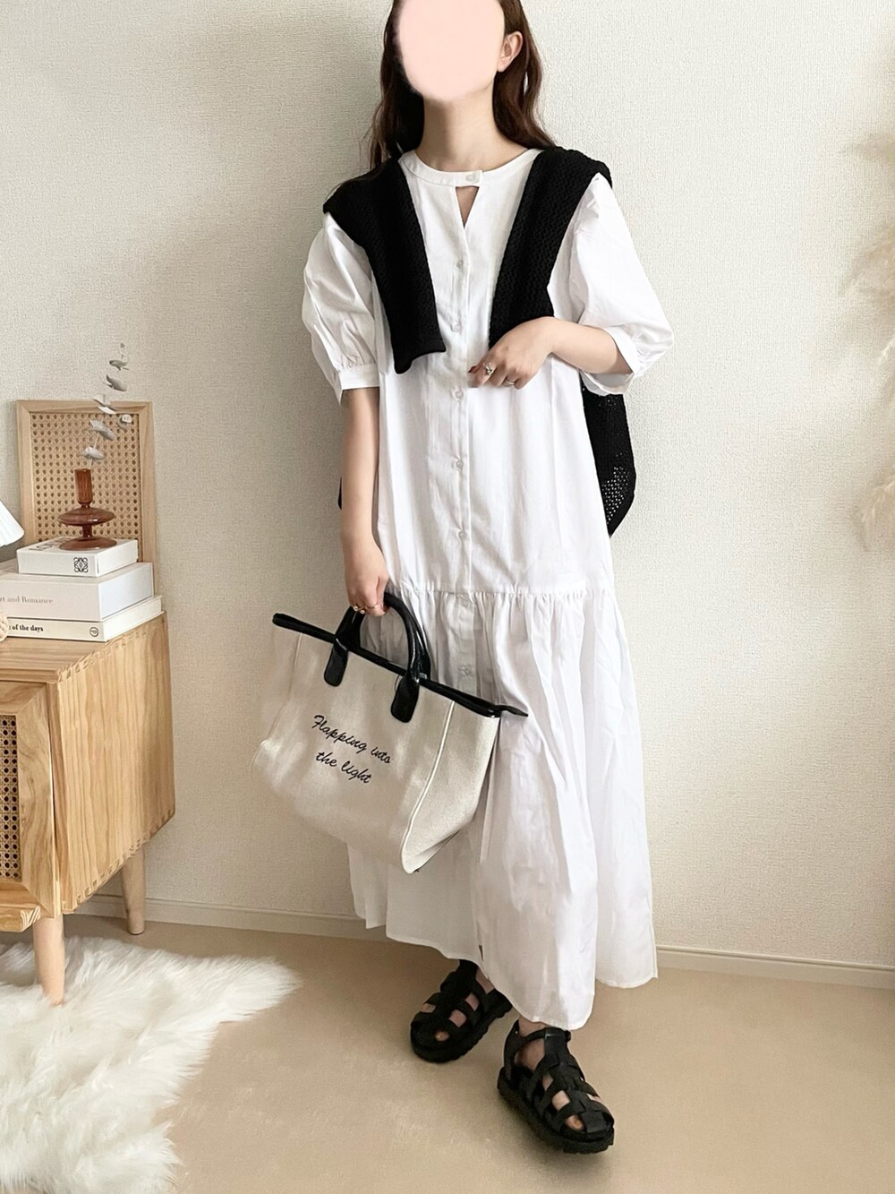 ホワイト系のシャツワンピース、ベージュ系のベスト、ブラウン系のトートバッグを着用したレディースの夏コーディネートの2枚目の写真