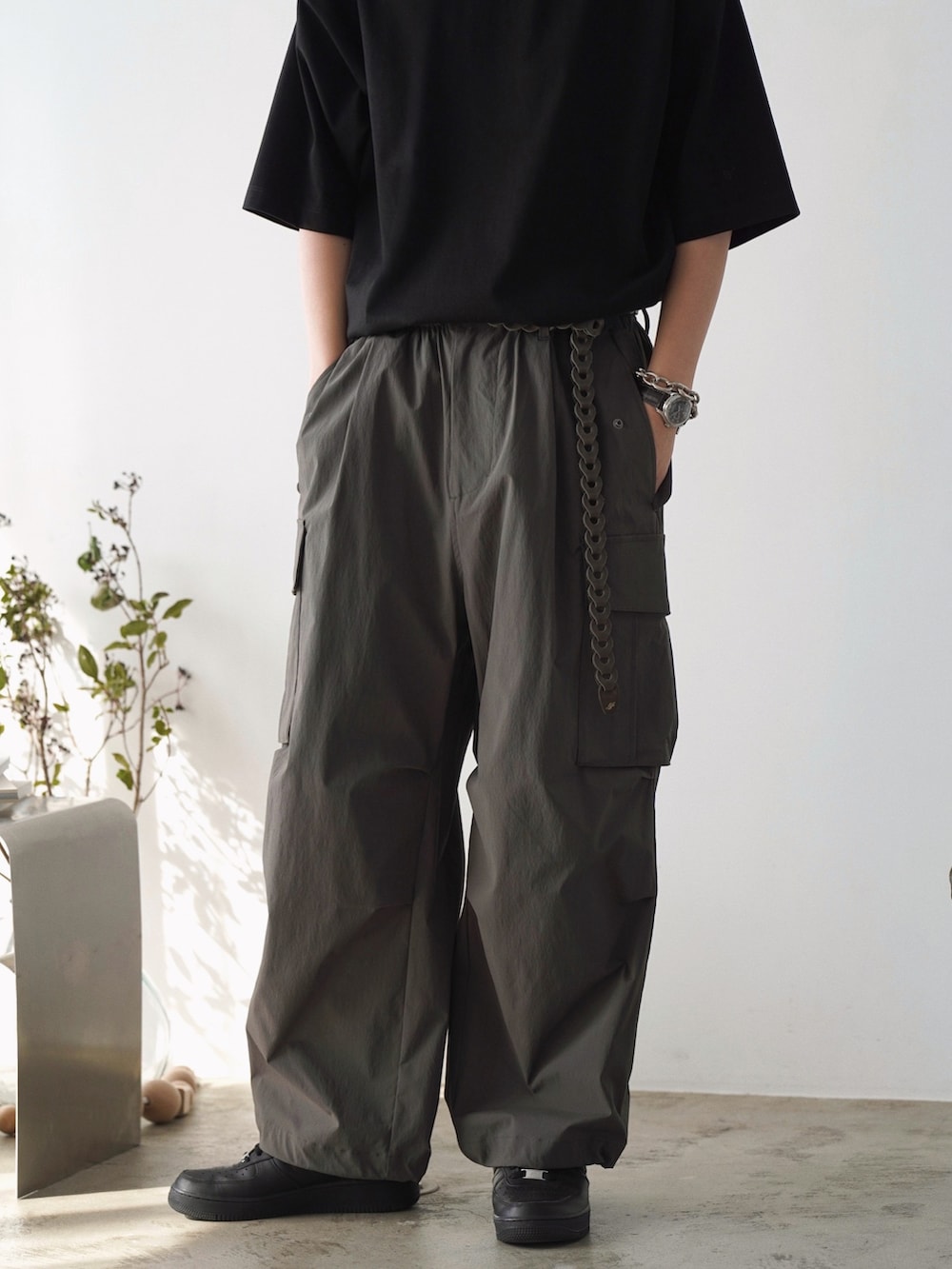 ブラック系のTシャツ/カットソー、ホワイト系のタンクトップ、グレー系のカーゴパンツを着用したメンズの夏コーディネートの3枚目の写真