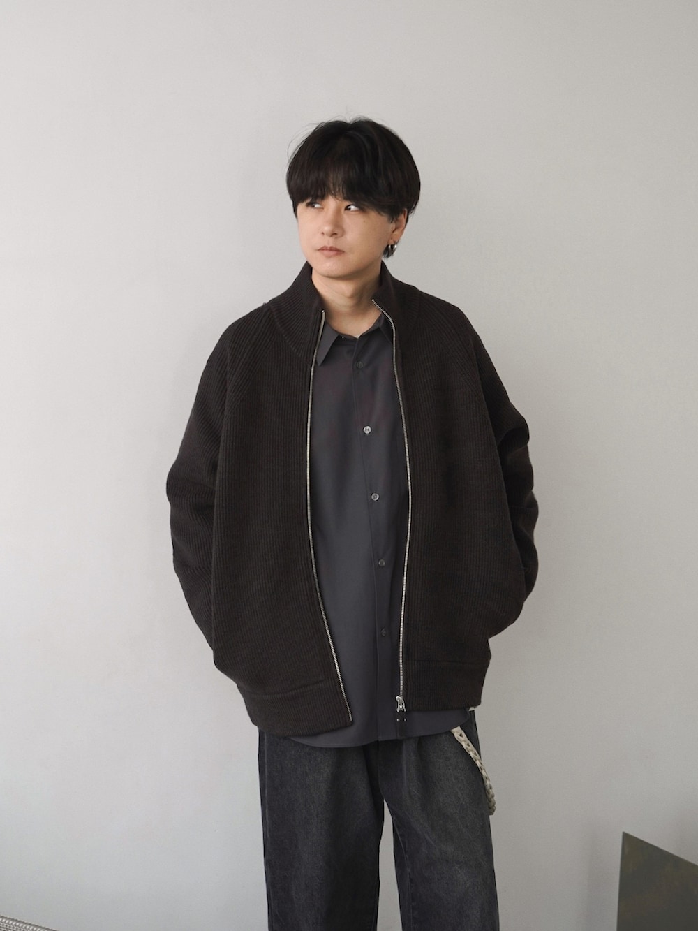 ブラック系のブルゾン、ブラウン系のカーディガン/ボレロ、グレー系のTシャツ/カットソーを着用したメンズの冬コーディネートの4枚目の写真