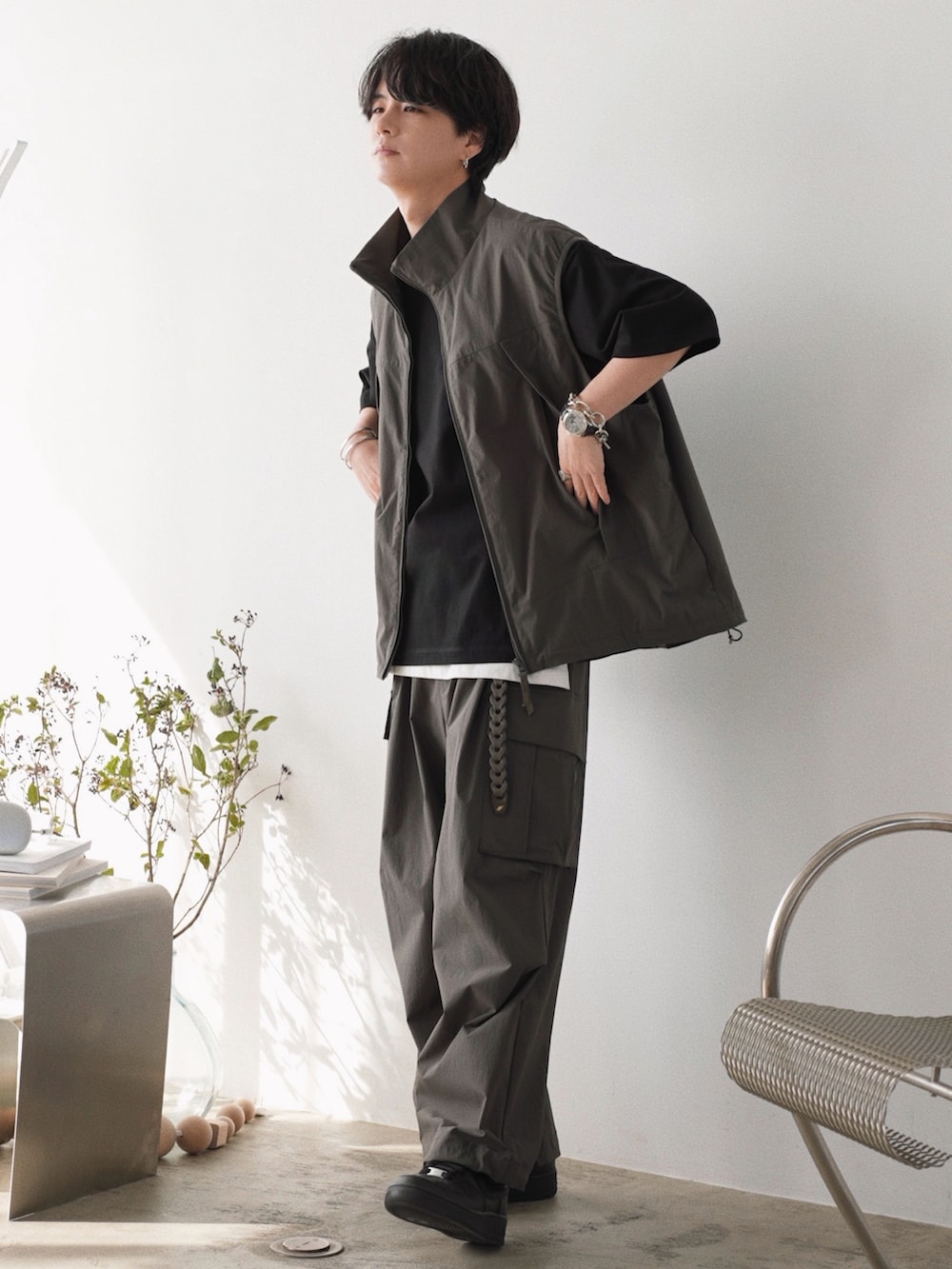 グレー系のベスト、ブラック系のTシャツ/カットソー、ホワイト系のタンクトップを着用したメンズの春コーディネートの3枚目の写真