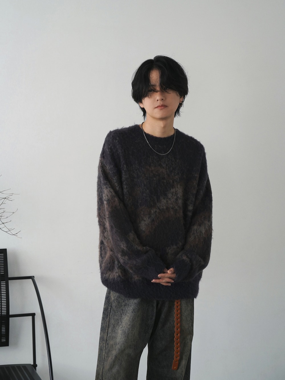 ブラック系のブルゾン、ブルー系のニット/セーター、ブルー系のデニムパンツを着用したメンズの秋コーディネートの5枚目の写真