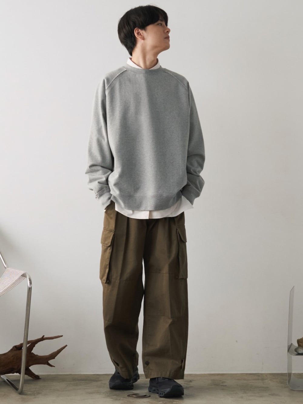 グレー系のスウェット、ホワイト系のシャツ/ブラウス、グリーン系のカーゴパンツを着用したメンズの冬コーディネートの2枚目の写真