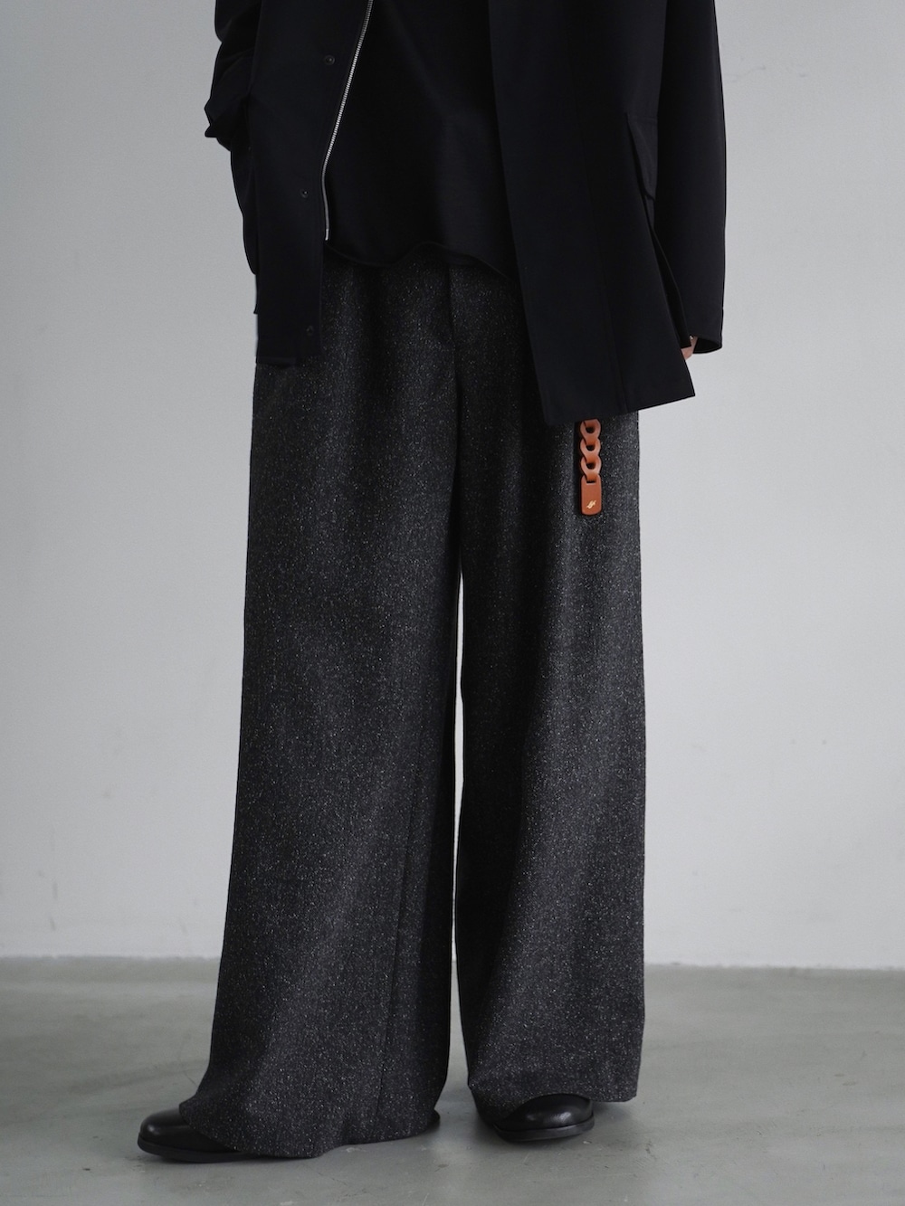 ブラック系のジャケット/アウター、ブラック系のスラックス、ブラック系のTシャツ/カットソーを着用したメンズの春コーディネートの3枚目の写真