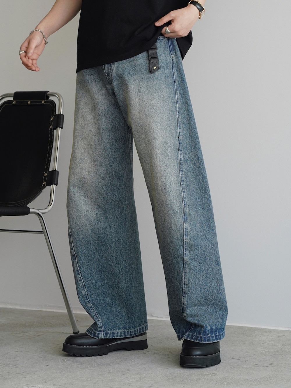 ブラック系のTシャツ/カットソー、ブルー系のデニムパンツ、ブラック系のドレスシューズを着用したメンズの春コーディネートの3枚目の写真