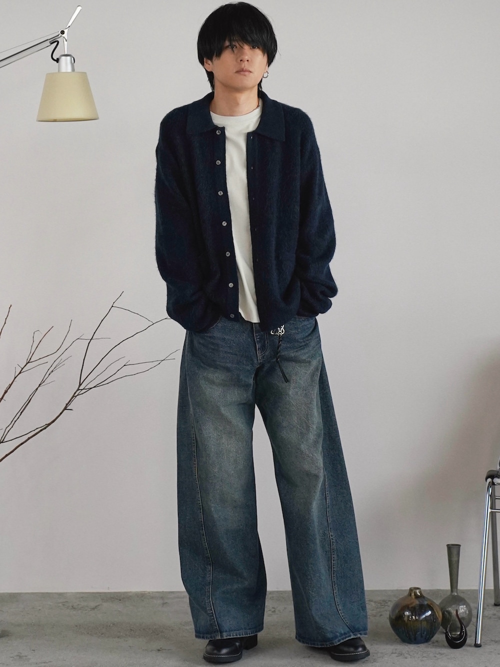 ブルー系のニット/セーター、ホワイト系のTシャツ/カットソー、ブルー系のデニムパンツを着用したメンズの秋コーディネートの2枚目の写真