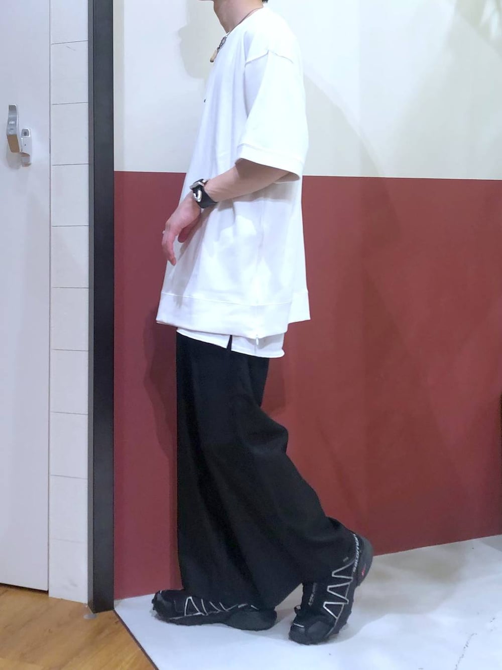 ブラック系のスラックス、ホワイト系のタンクトップ、ホワイト系のTシャツ/カットソーを着用したメンズの秋コーディネートの2枚目の写真