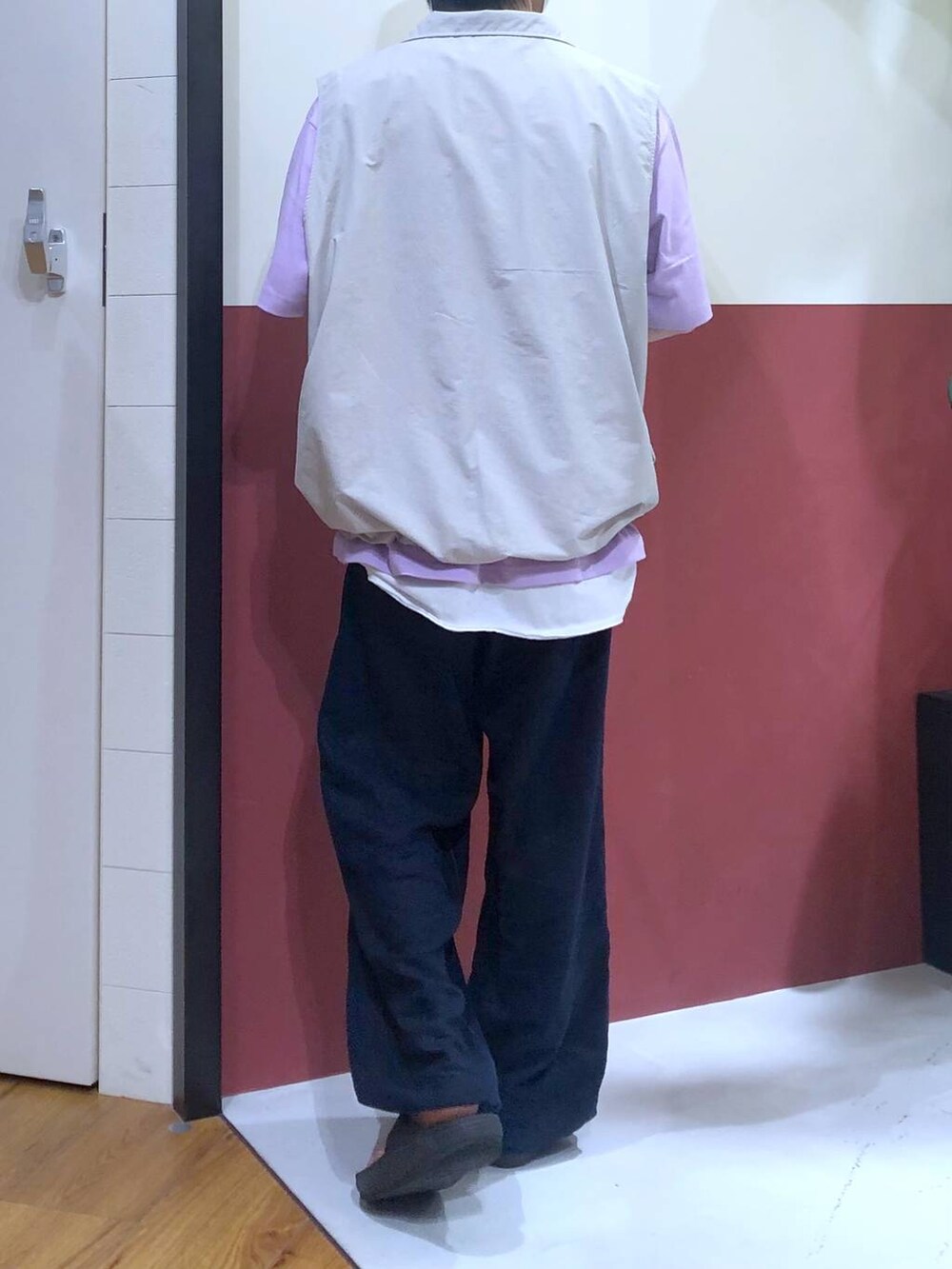 グレー系のベスト、ホワイト系のタンクトップ、ブラック系のサンダルを着用したメンズの夏コーディネートの3枚目の写真