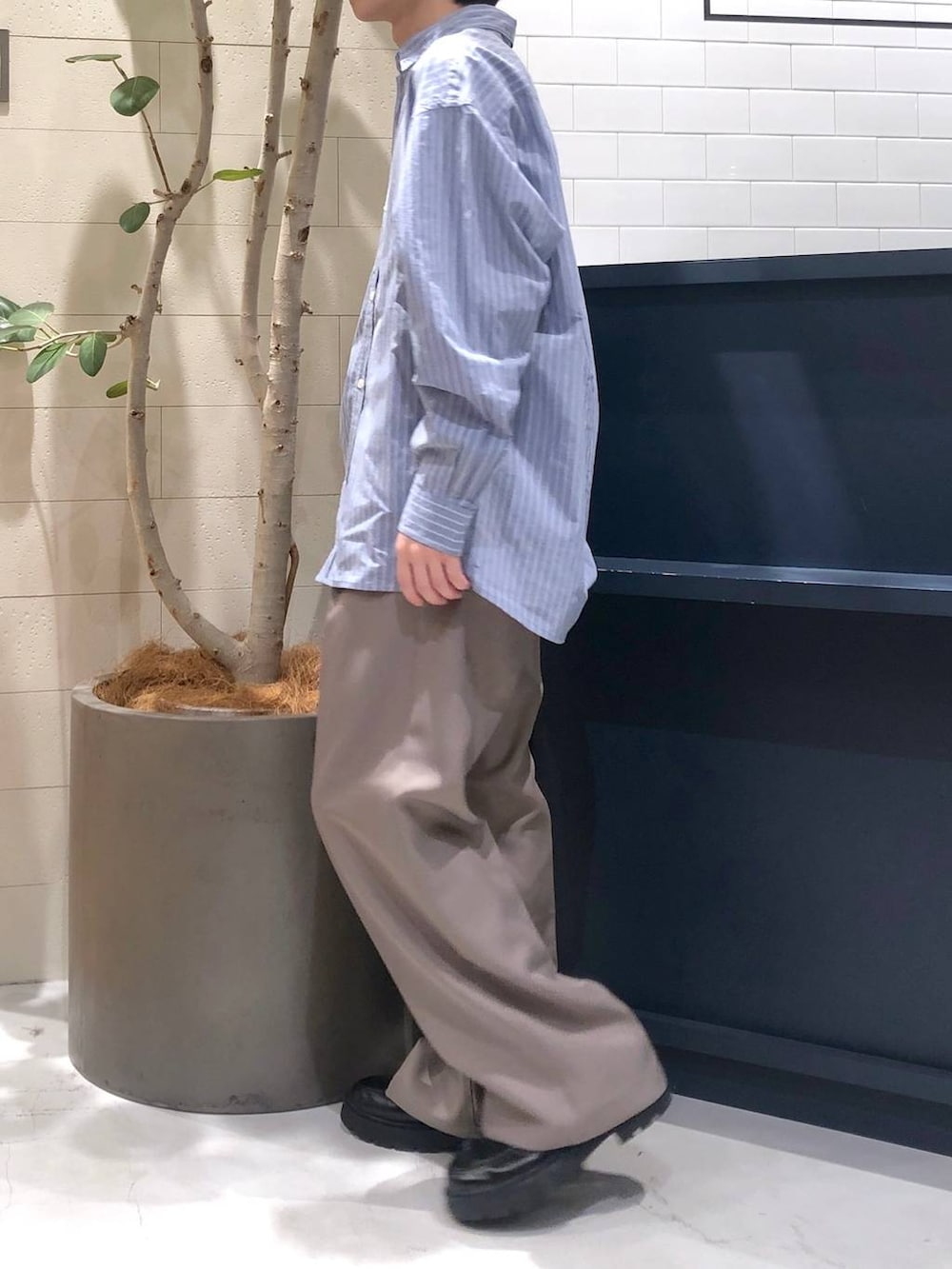 ベージュ系のスラックス、ブルー系のシャツ/ブラウス、シルバー系のリングを着用したメンズの秋コーディネートの2枚目の写真